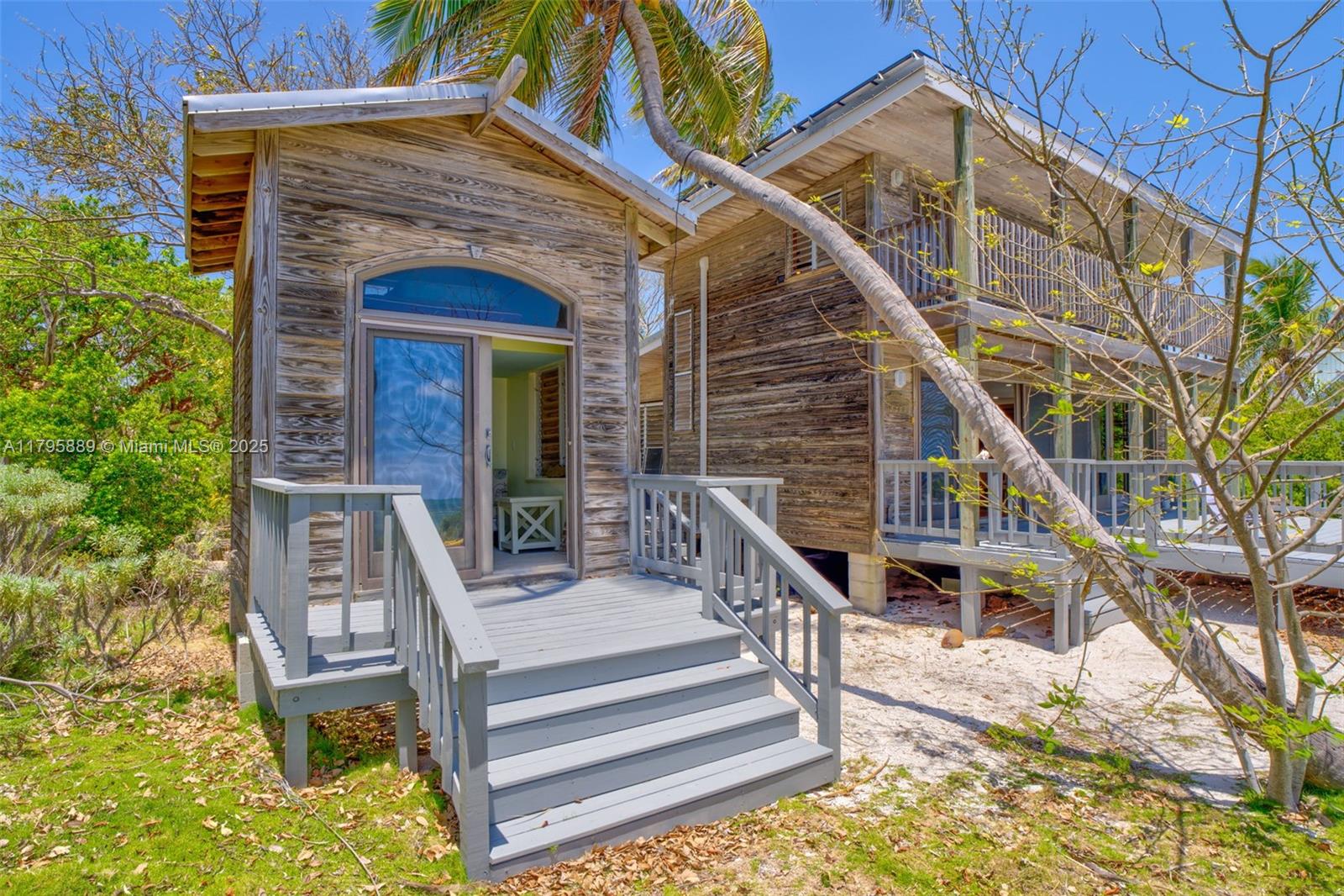 Lower Keys Big Pine Key, FL 33043 - Photo 23 of 43 a front view of a house with a yard