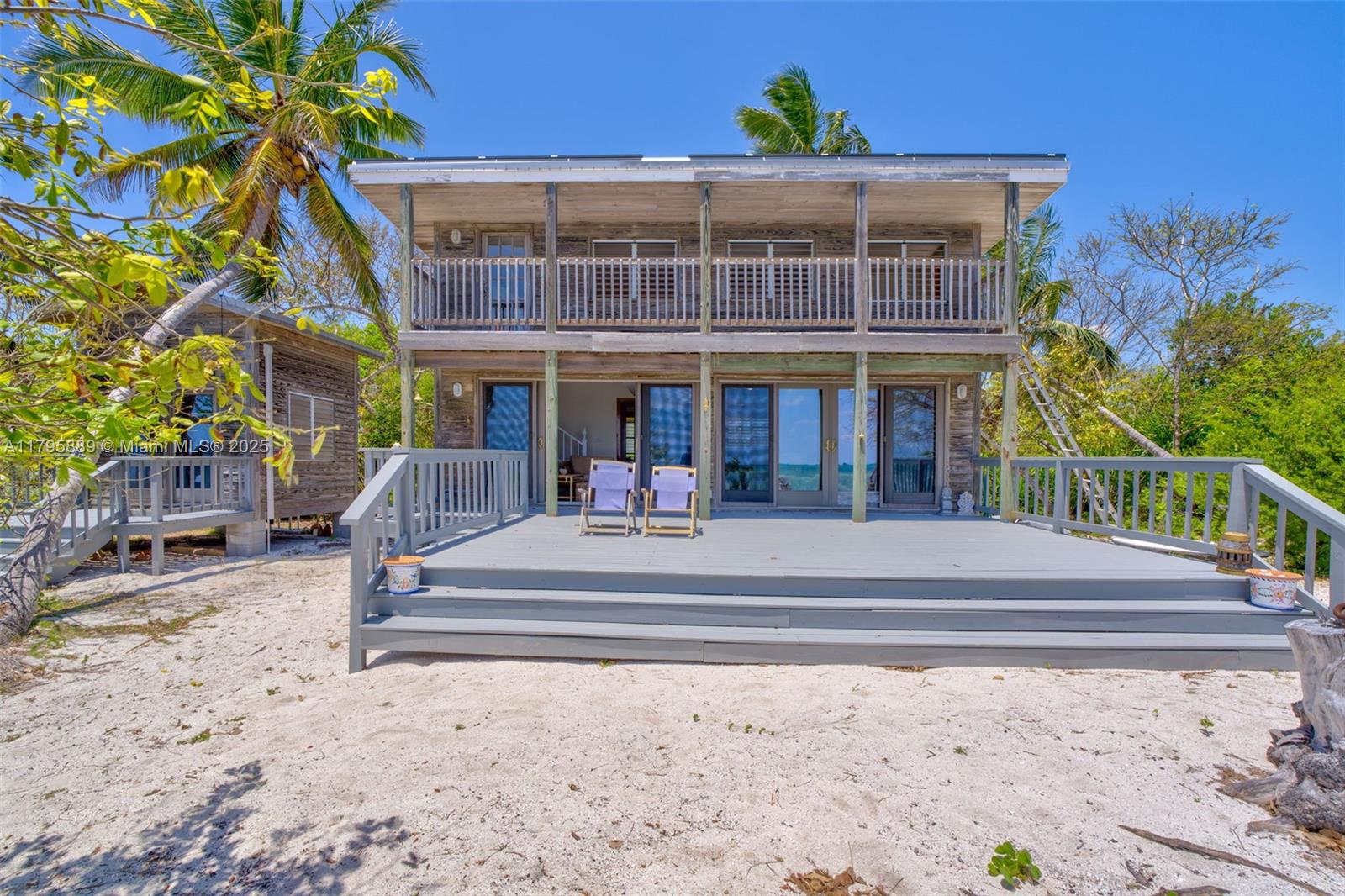 Lower Keys Big Pine Key, FL 33043 - Photo 28 of 43 a man sitting on a bench in front of a building