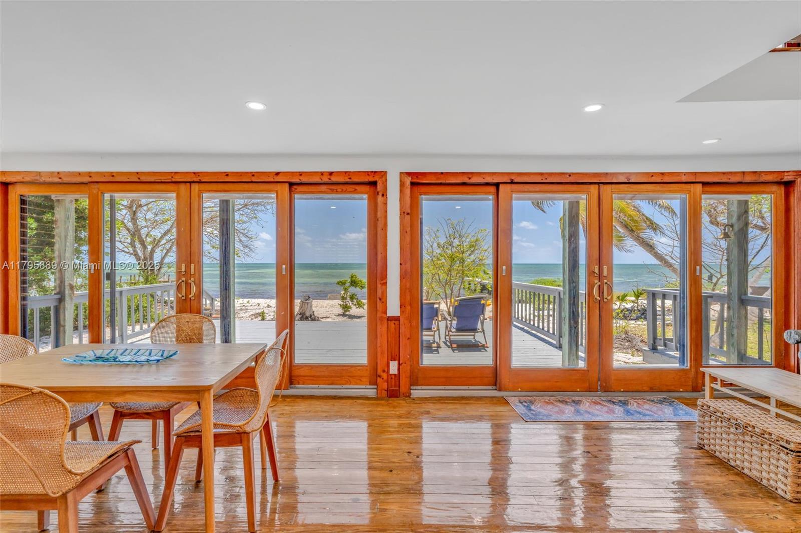 Lower Keys Big Pine Key, FL 33043 - Photo 5 of 43 a living room with large windows and a table