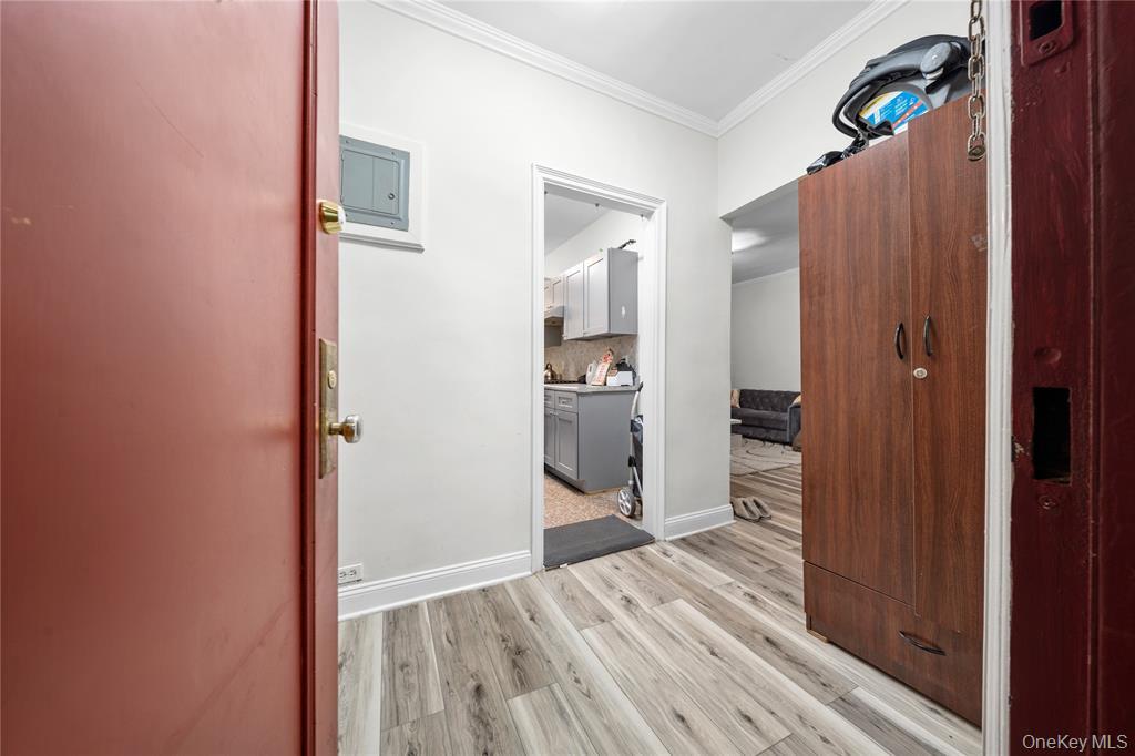 43-33 48th Street, Unit 3B Queens, NY 11104 - Photo 11 of 13 a view of a bedroom with wooden floor & bathroom