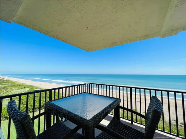 a view of a balcony with furniture