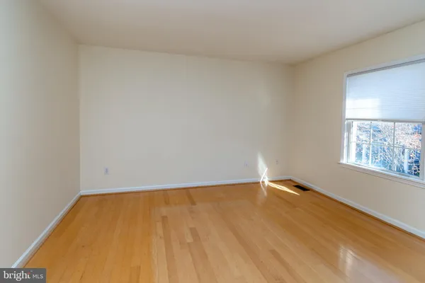 a view of room with window and hardwood floor