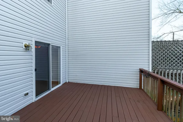 a view of a room with wooden floor and entryway