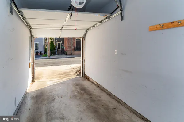a view of brick house with large windows and a small yard