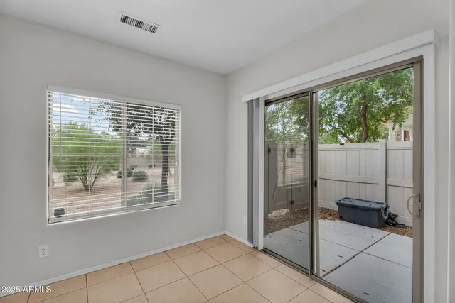 a kitchen with granite countertop a sink a stove top oven and cabinetry
