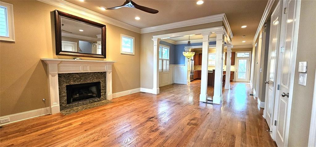 a view of a livingroom with wooden floor and a fireplace