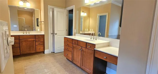 a spacious bathroom with a double vanity sink mirror and double