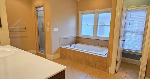 a bathroom with a tub and shower