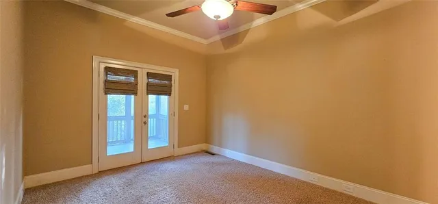 an empty room with a ceiling fan and window