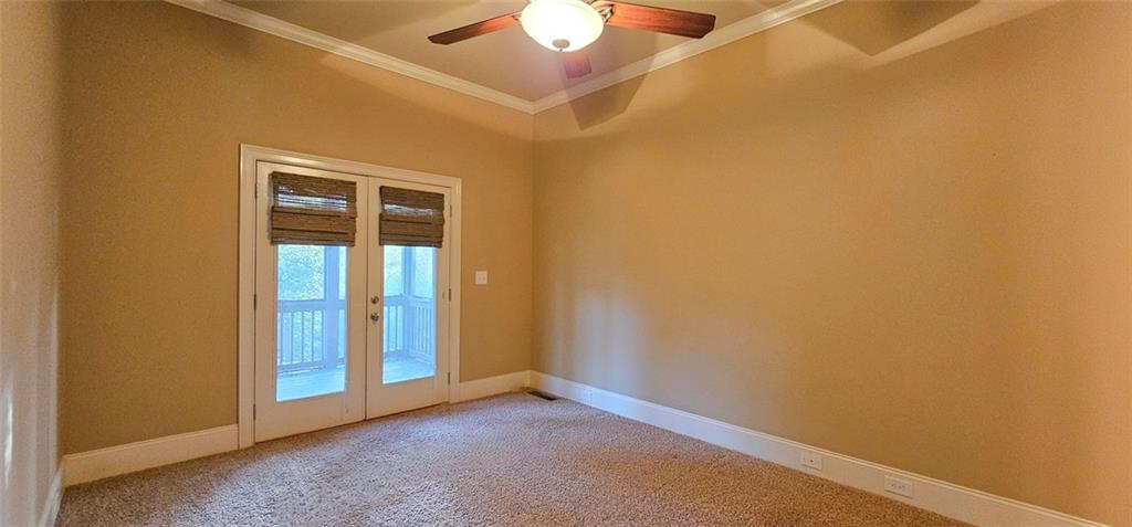 703 Pershing Avenue Southeast Atlanta, GA 30312 - Photo 13 of 26 an empty room with a ceiling fan and window