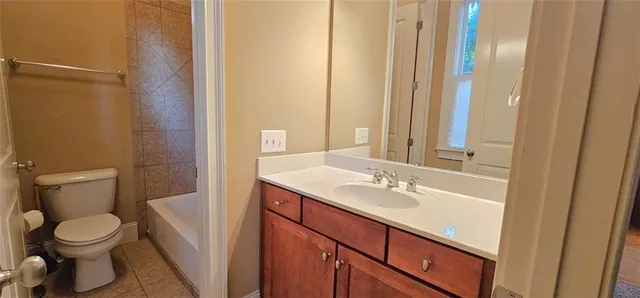 a bathroom with a toilet a sink and a mirror