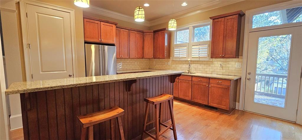 703 Pershing Avenue Southeast Atlanta, GA 30312 - Photo 5 of 26 a kitchen with stainless steel appliances granite countertop a refrigerator a sink dishwasher and wooden cabinets with wooden floor