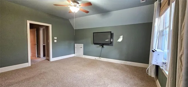 a view of a livingroom with a chandelier fan and a bathroom