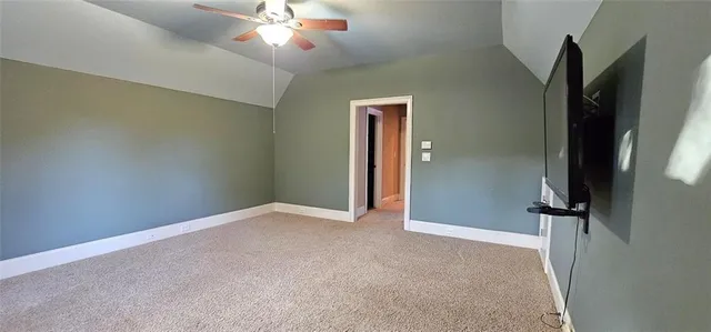 an empty room with closet and a chandelier fan