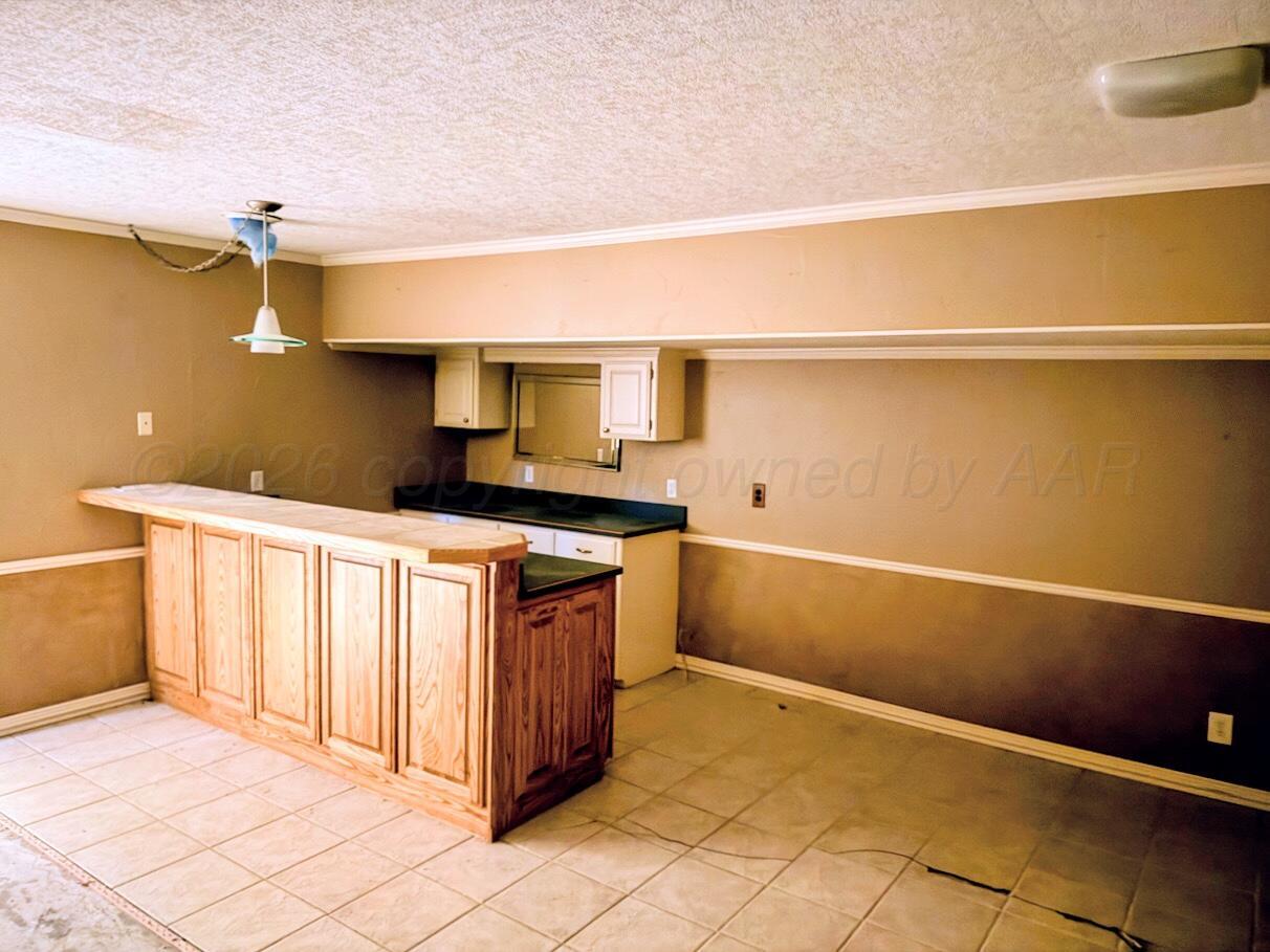 714 South Harvard Street Perryton, TX 79070 - Photo 18 of 27 a kitchen with a sink and cabinets