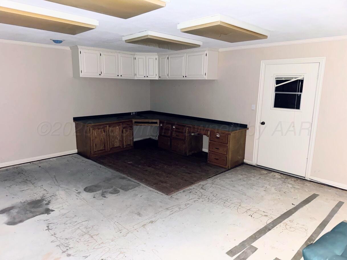 714 South Harvard Street Perryton, TX 79070 - Photo 19 of 27 a room with a stove and a cabinet