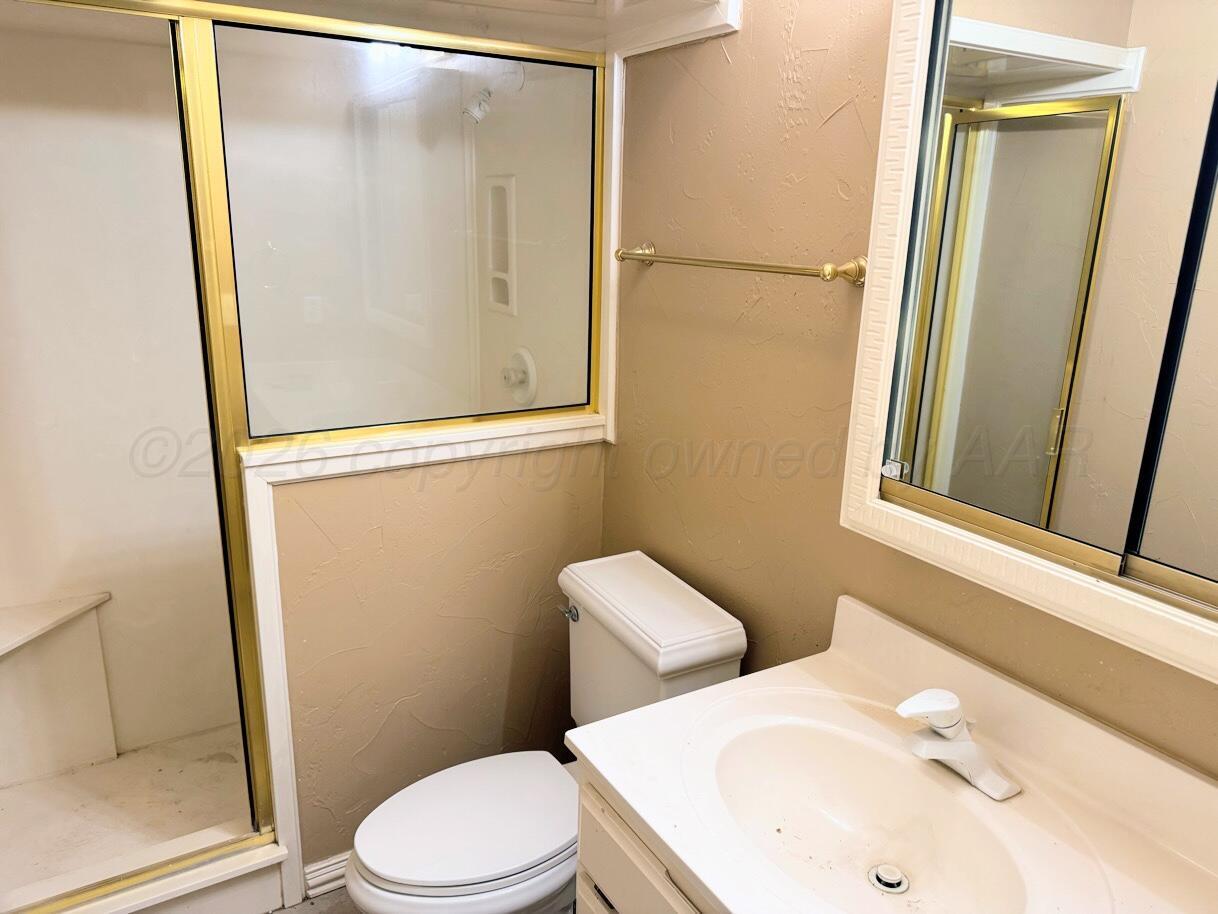714 South Harvard Street Perryton, TX 79070 - Photo 21 of 27 a white toilet sitting next to a bathroom sink