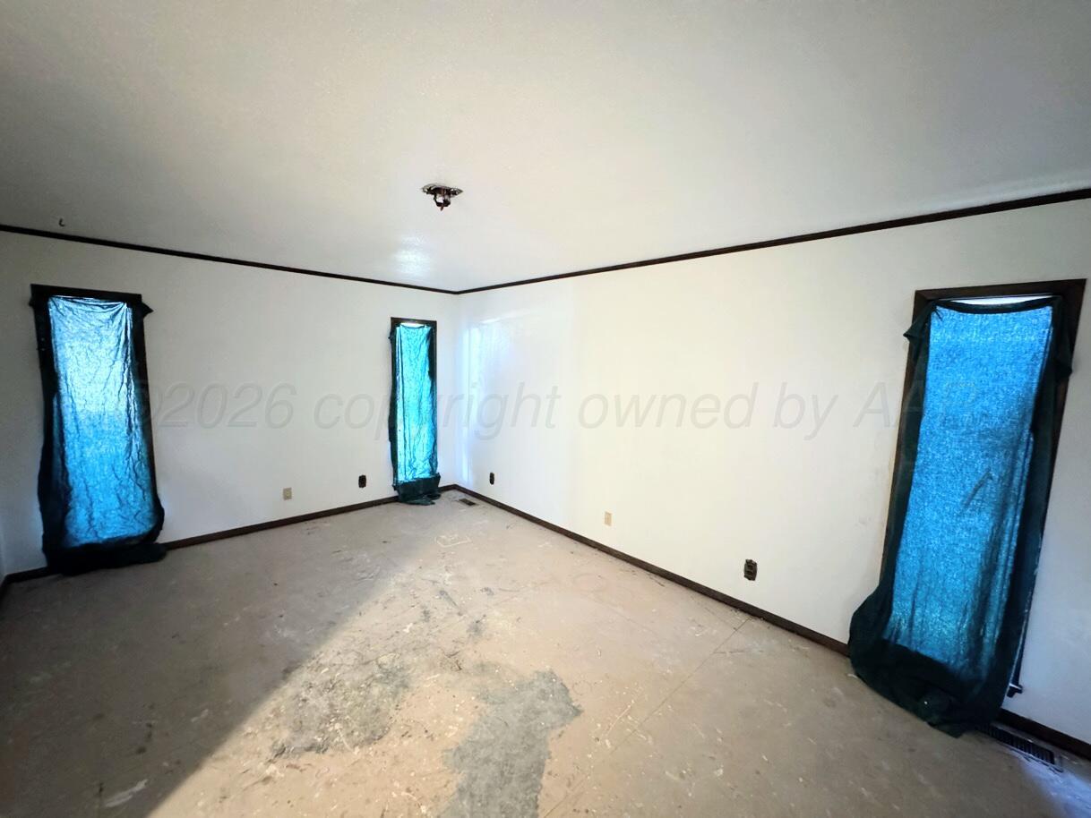 714 South Harvard Street Perryton, TX 79070 - Photo 6 of 27 a view of a room with wooden floor