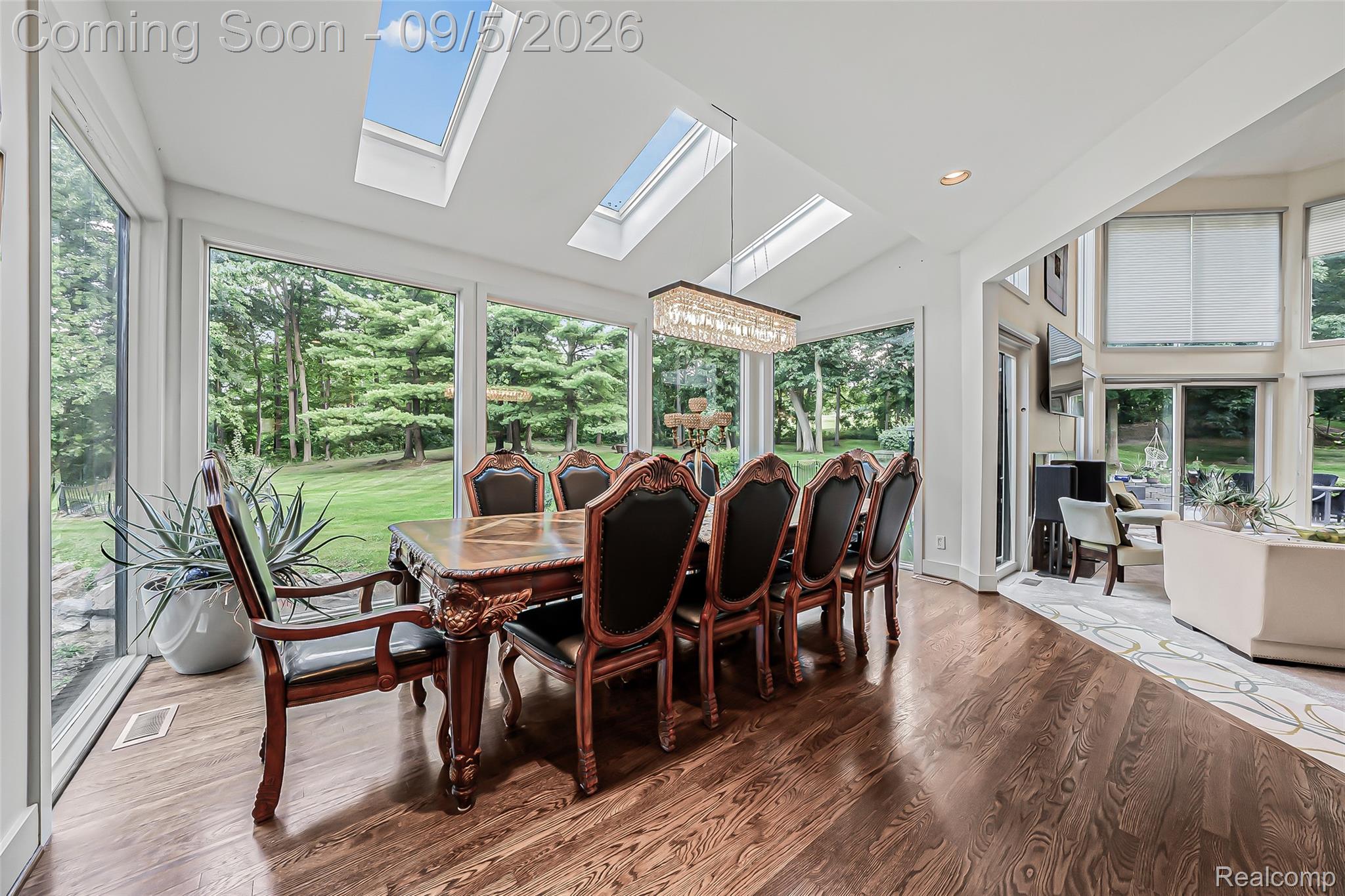 2785 Cranbrook Ridge Court Rochester, MI 48306 - Photo 47 of 97 Vaulted ceiling with multiple skylights, full-height windows, wood-finish flooring, and an elegant rectangular chandelier
