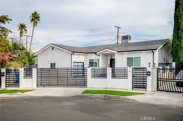a view of a house with a patio and a yard