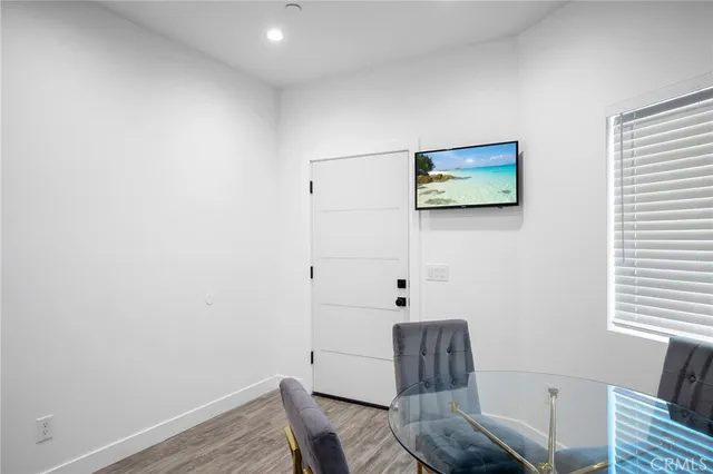 a view of a room with furniture and wooden floor