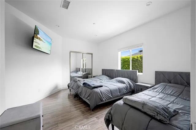 a bedroom with two beds and a window