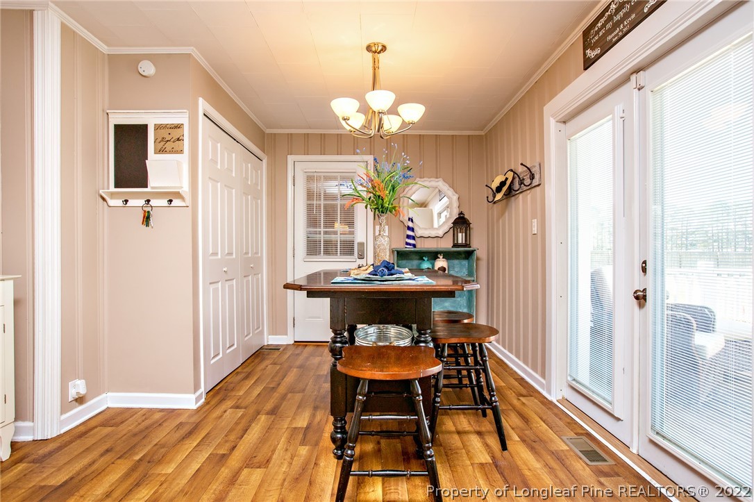7845 Maxwell Road Stedman, NC 28391 - Photo 10 of 31 a view of a dining room with furniture and a chandelier