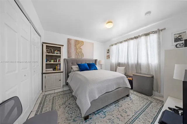 a bedroom with a large bed and a couch