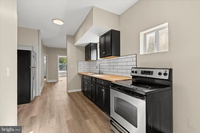 a kitchen with stainless steel appliances a stove sink and microwave