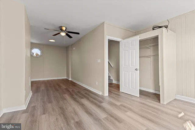 a view of an empty room and wooden floor