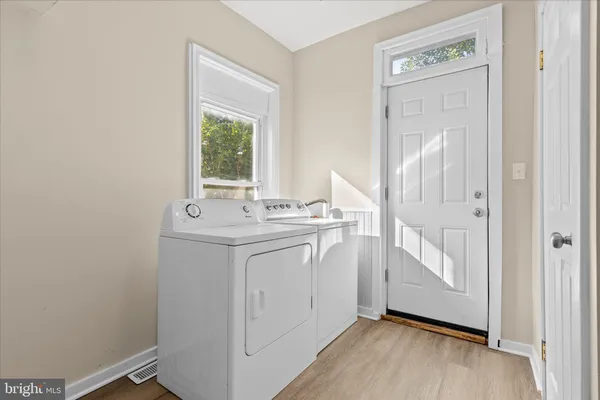 a view of entryway with window and wooden floor