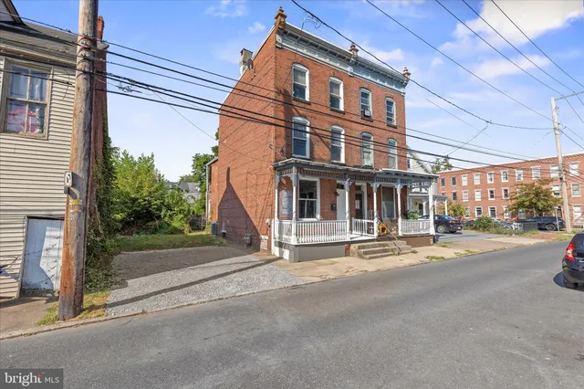 a view of a brick building next to a yard