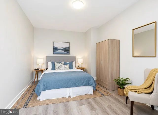 a bedroom with a bed and chair