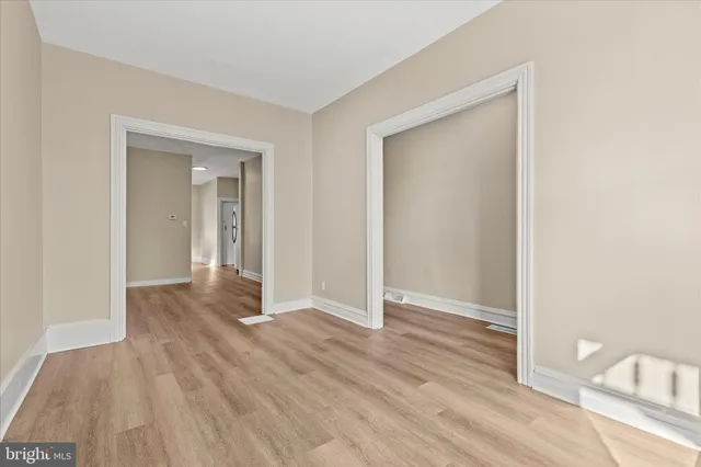 a view of hallway with wooden floor