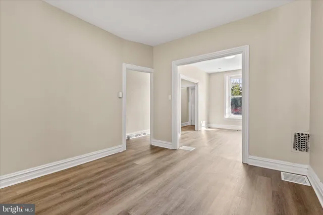 a view of a room with wooden floor