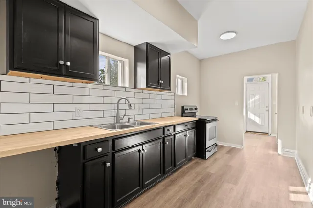 a kitchen with stainless steel appliances a sink dishwasher stove and cabinets