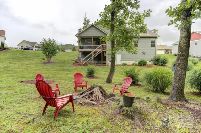a backyard of a house with table and chairs