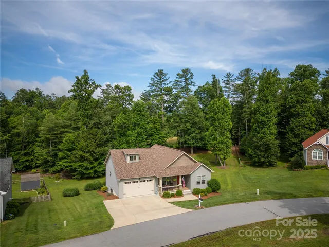 a aerial view of a house with a yard and garage