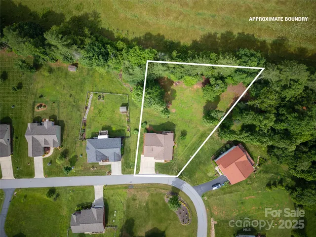 an aerial view of multiple houses with a yard