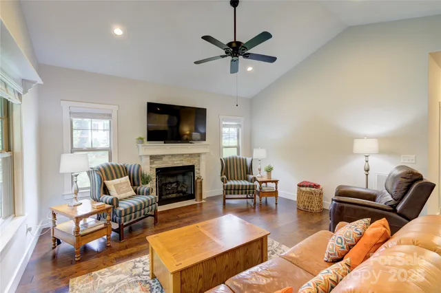 a living room with furniture fireplace and a flat screen tv