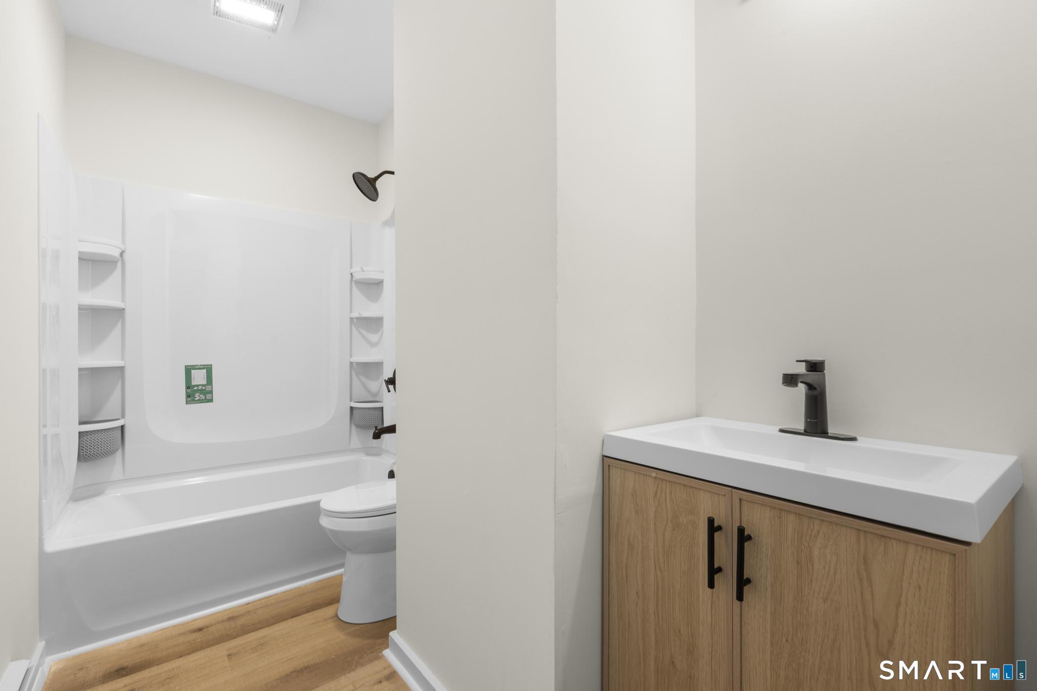 704 Maple Street, Unit 704 Bridgeport, CT 06608 - Photo 11 of 15 a bathroom with a sink a toilet and a bathtub