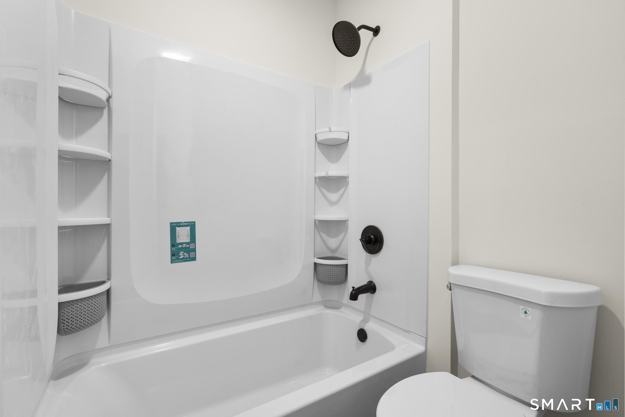 704 Maple Street, Unit 704 Bridgeport, CT 06608 - Photo 12 of 15 a bathroom with a toilet and a bathtub