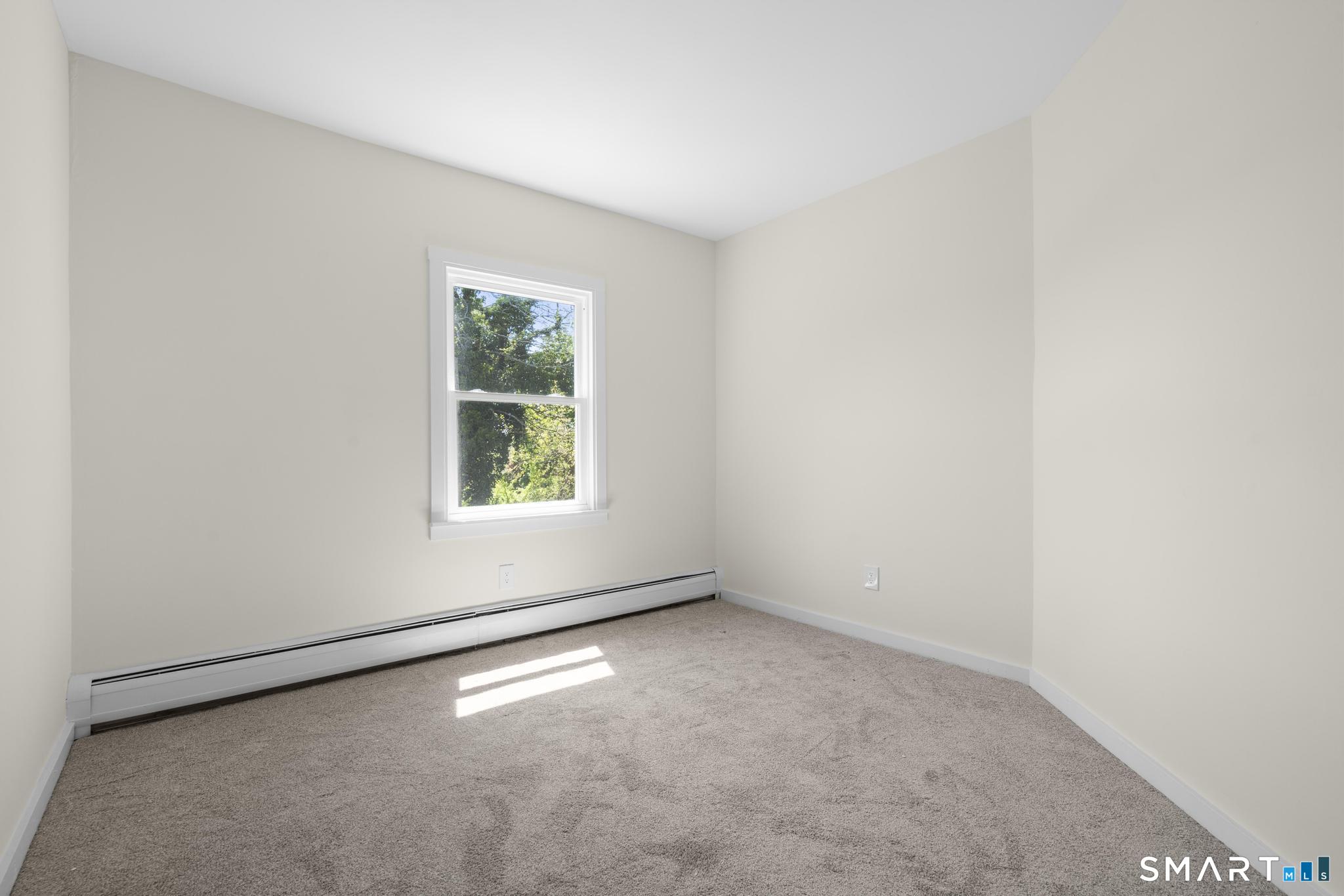 704 Maple Street, Unit 704 Bridgeport, CT 06608 - Photo 15 of 15 an empty room with a window