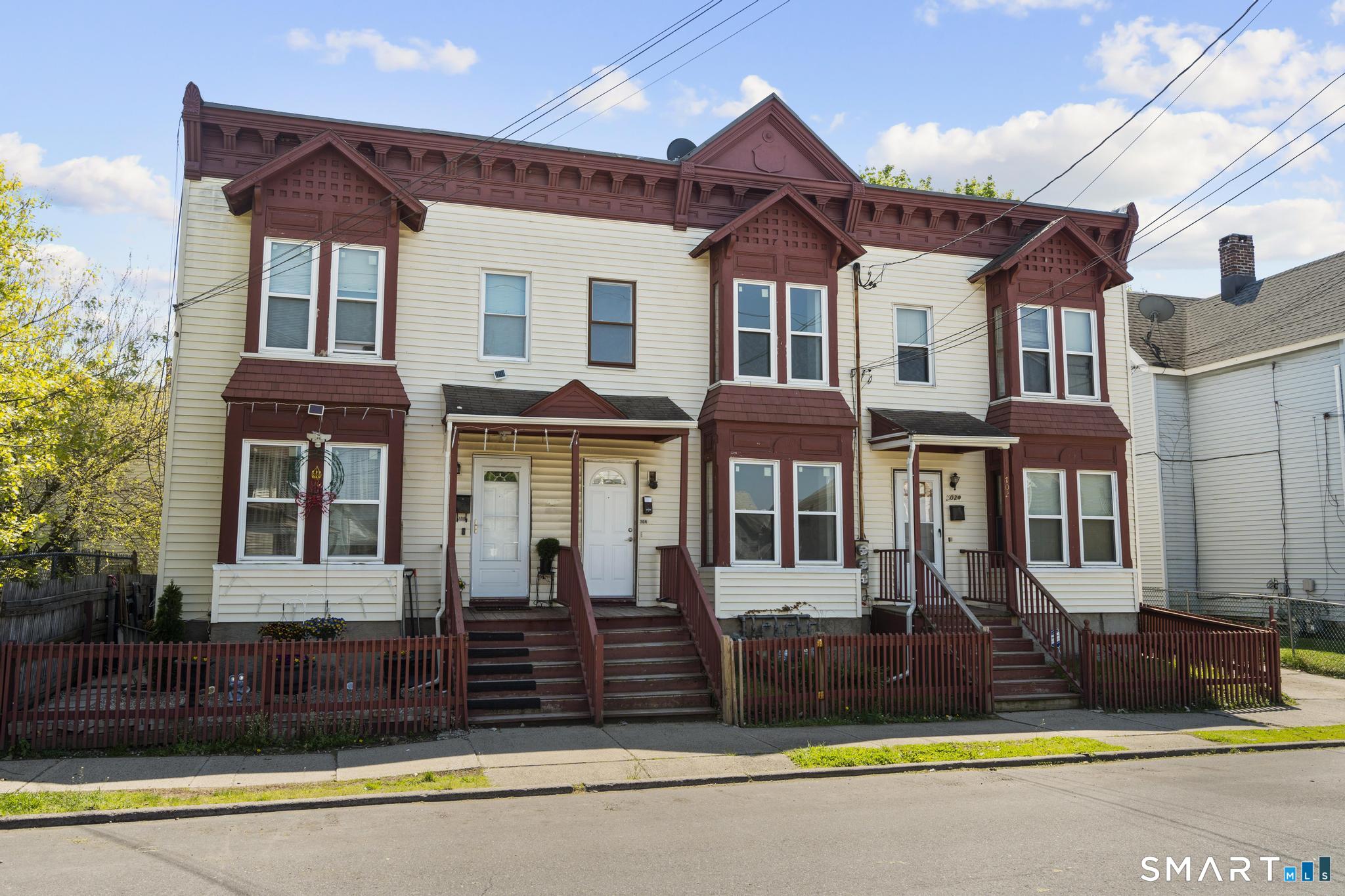 704 Maple Street, Unit 704 Bridgeport, CT 06608 - Photo 3 of 15 a front view of a house with a yard