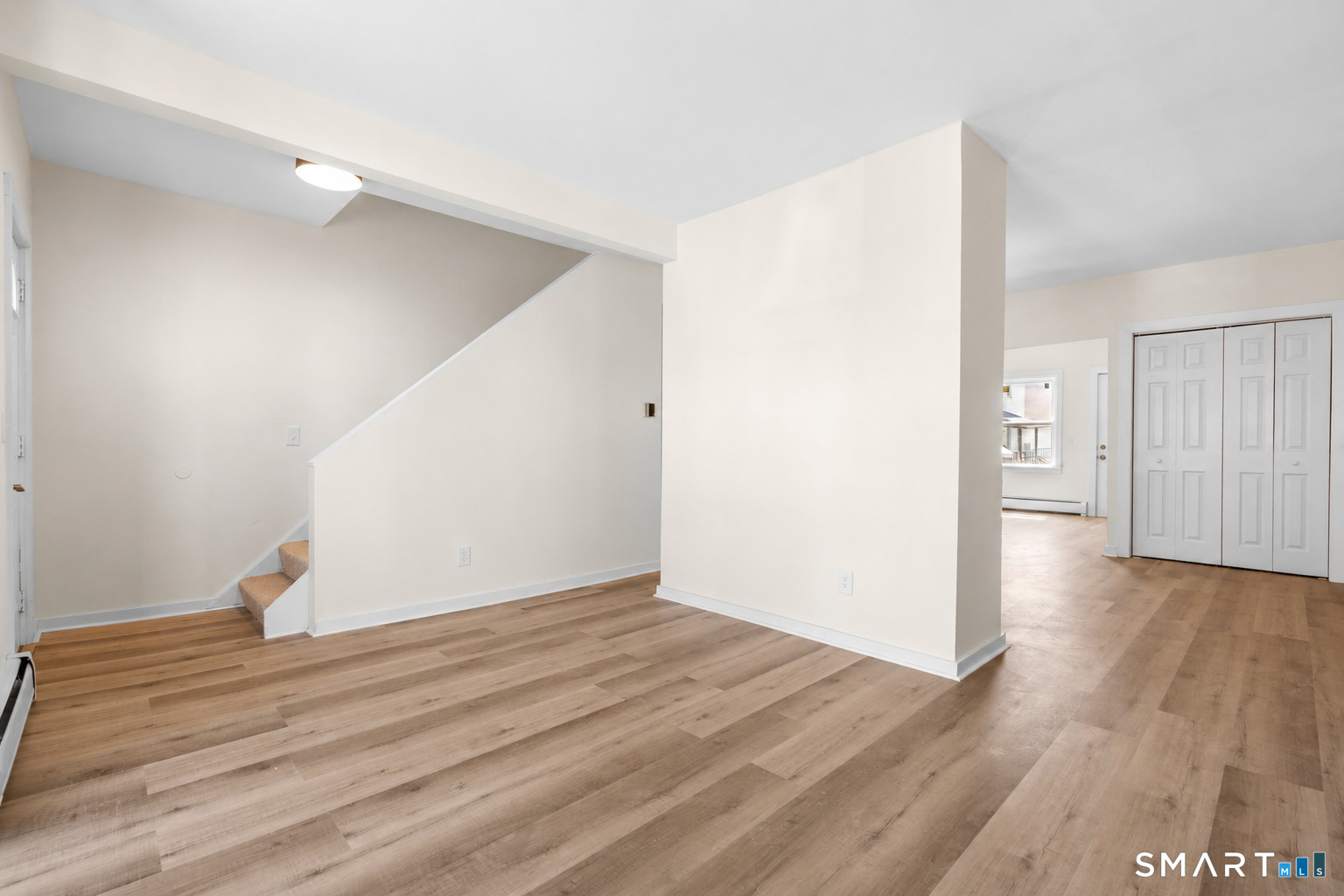704 Maple Street, Unit 704 Bridgeport, CT 06608 - Photo 5 of 15 a view of an empty room with wooden floor
