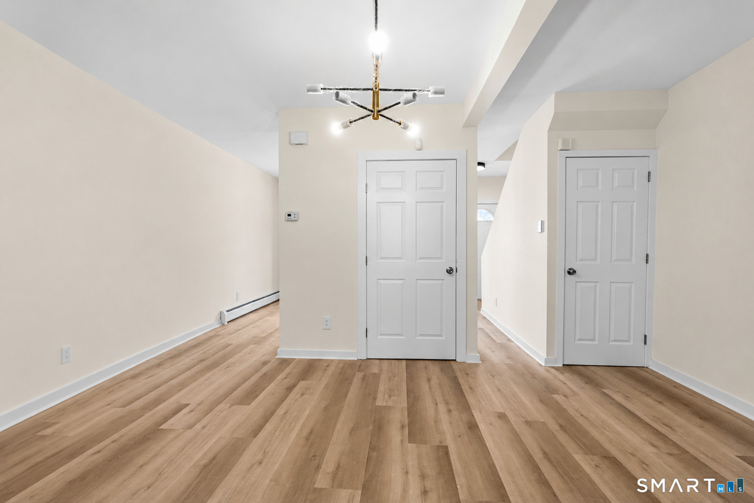 704 Maple Street, Unit 704 Bridgeport, CT 06608 - Photo 6 of 15 wooden floor in an empty room with a window