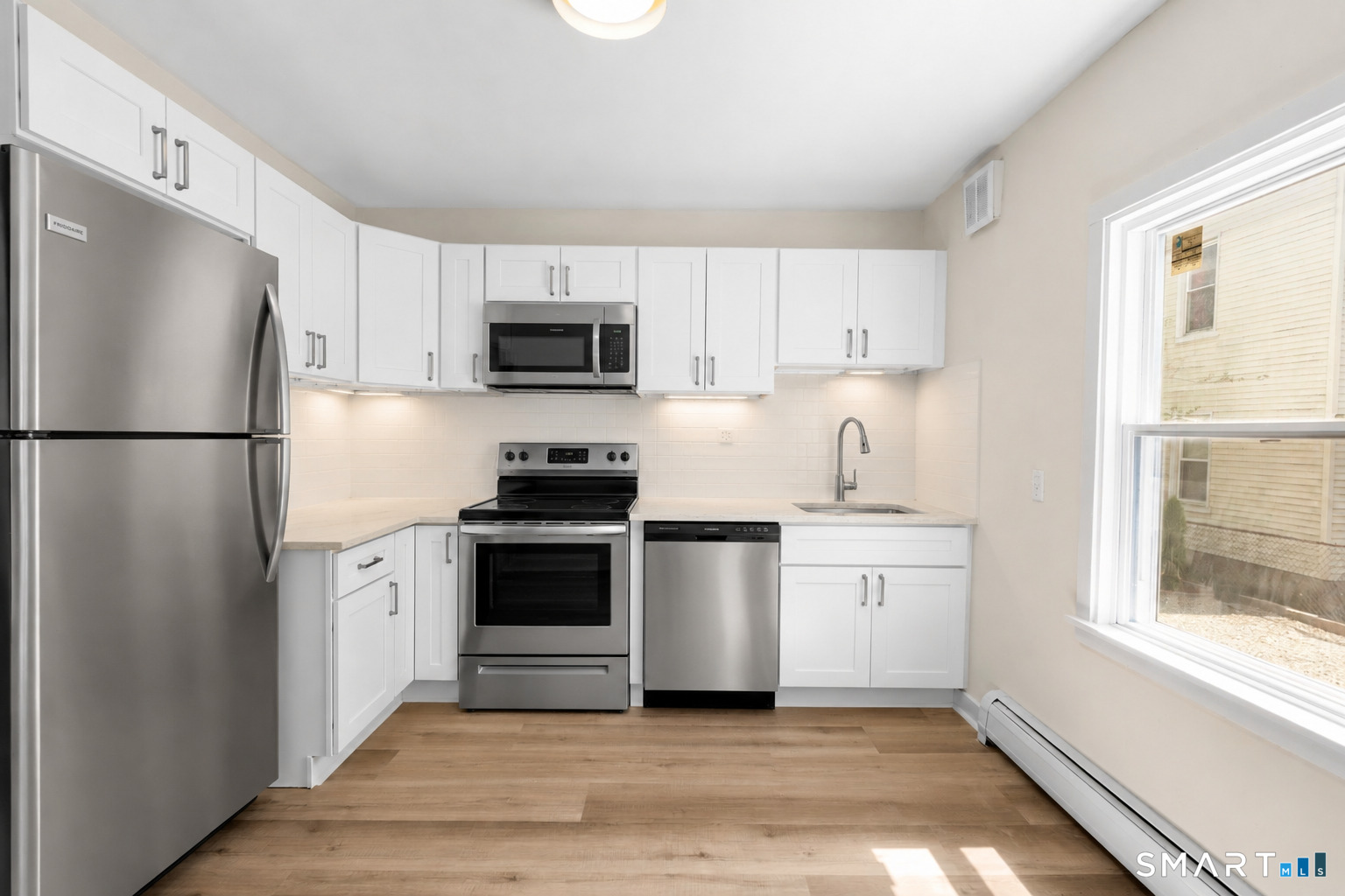 704 Maple Street, Unit 704 Bridgeport, CT 06608 - Photo 7 of 15 a kitchen with a refrigerator stove and microwave