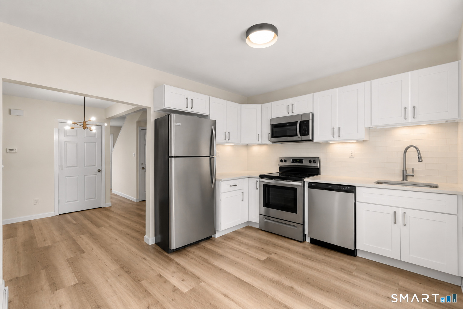 704 Maple Street, Unit 704 Bridgeport, CT 06608 - Photo 8 of 15 a kitchen with a refrigerator stove and sink