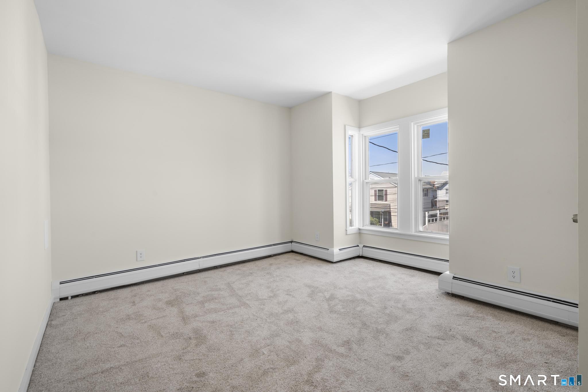 704 Maple Street, Unit 704 Bridgeport, CT 06608 - Photo 9 of 15 a view of an empty room with a window