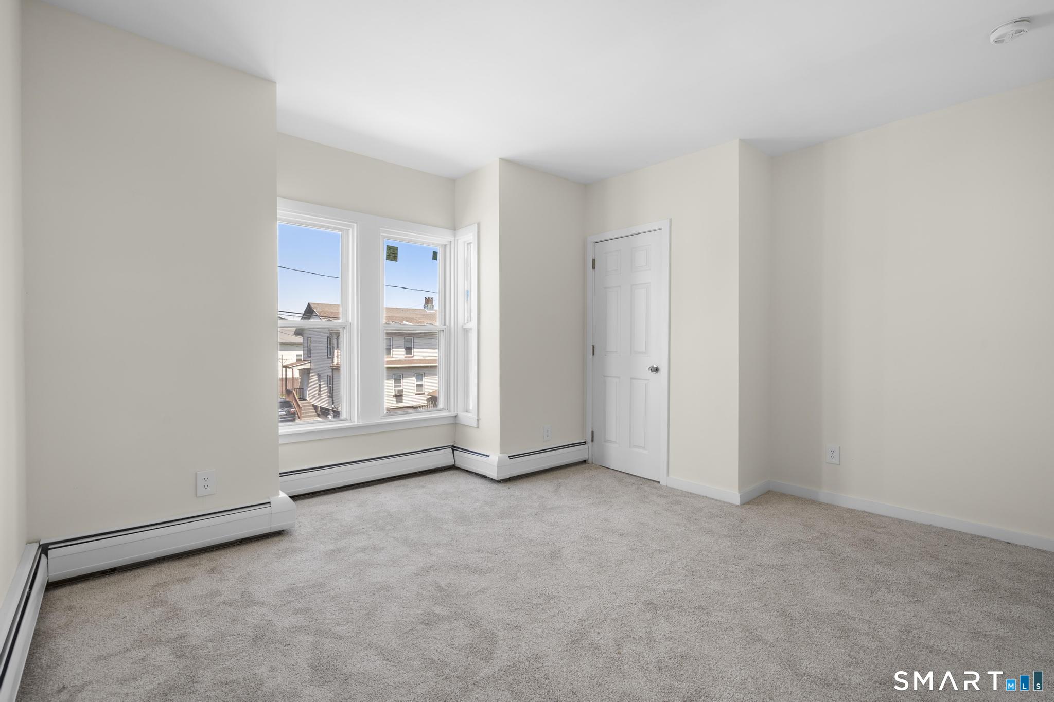 704 Maple Street, Unit 704 Bridgeport, CT 06608 - Photo 10 of 15 a view of an empty room with a window